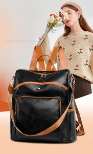 Detail of vintage patchwork backpack with geometric texture and caramel contrast straps