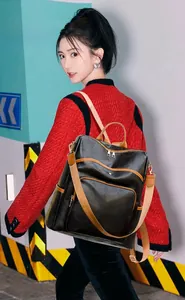 Detail of vintage patchwork backpack with black PU leather and brown straps on model