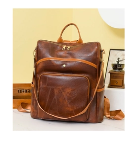 Detail view of vintage brown patchwork backpack with geometric stitching and gold hardware