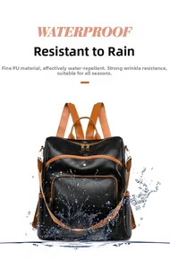 Detailed view of waterproof black pebbled PU leather backpack with brown strap contrast