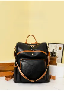 Close-up of the vintage faux leather backpack with brown contrast corner stitching detail