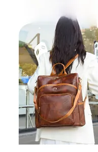 Rear view of a dark brown vintage PU leather backpack for women with TO TRAVEL text