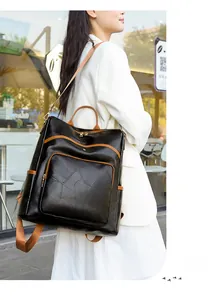 Detail of a large women's backpack with geometric black and brown faux leather patchwork