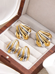 Detail von Muschelohrringen in Gold und Silber auf Samtfutter in Schmuckbox
