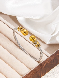 Detail view of vintage twisted cable bracelet with pavé diamond gold ends on velvet