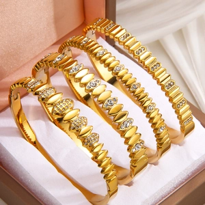 Set of four 18k gold plated stainless steel bracelets with zirconia in jewelry box