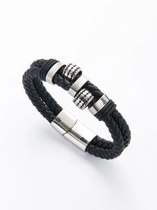 Macro shot of men's multi-strand black braided leather bracelet with silver magnetic clasp