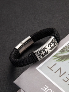 Detailed view of punk braided leather bracelet with vintage silver cross clasp