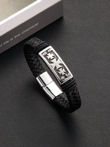 Close-up of black braided leather bracelet featuring a silver cross metal plate and clasp