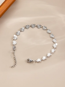 Detailed macro shot of silver heart-shaped links on a delicate stainless steel bracelet