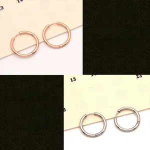 Macro view of rose gold and silver hypoallergenic stainless steel hoop earrings