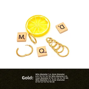 Detail view of gold stainless steel hoop earrings in various wire and inner diameters