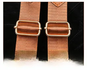 Detail of adjustable nylon shoulder straps with premium gold metal buckles and leather trim
