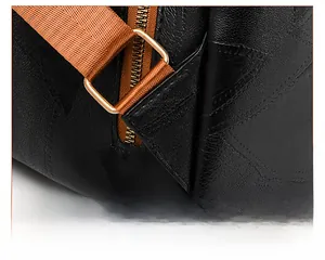 Detail of reinforced triangle stitching on lychee texture backpack with orange strap