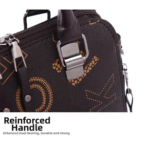 Close-up of reinforced handle with silver metal buckle and litchi texture printed leather
