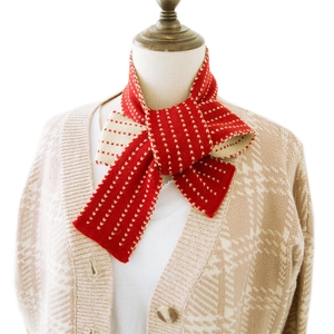 Red and white striped knit scarf on model neck with casual khaki plaid sweater look