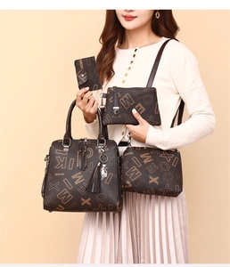 Detailed four-piece set of printed handbags in dark brown leather with cat charm and tassel