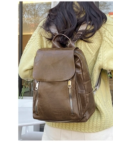 Detail of vintage brown leather backpack texture with stylish parallel metal zippers