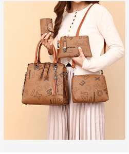 Detail view of the 4-in-1 brown leather bag set with floral print and cat pendant