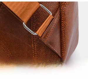 Close-up of reinforced stitching and silver metal buckle on brown leather backpack strap