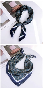 Detail of leopard print silk scarf with navy blue and white contrast striped border