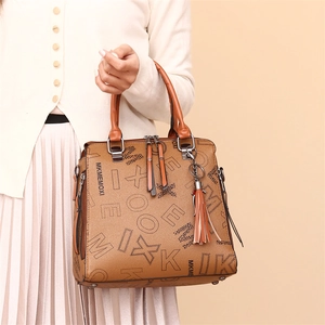Brown printed leather tote bag with tassel charm and double handles for women