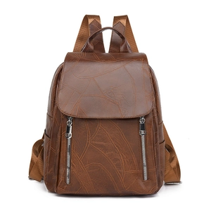 Deep brown minimalist backpack with leaf texture and dual front zippers in a soft finish
