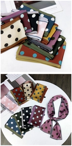 Close-up of assorted polka dot scarves showing silk texture and vibrant color variety