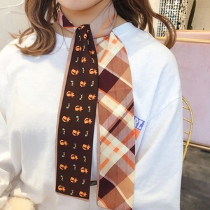 Detail of double-sided scarf showing cat patterns and geometric check design