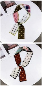 Detail of long double-sided twilly scarves with geometric patterns and cat prints