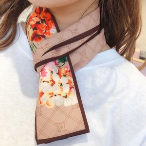 Detail of floral silk scarf in nude pink with brown trim and classic chain pattern