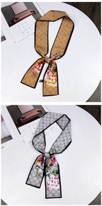 Close-up of retro geometric twilly scarves with realistic floral prints and sleek edges