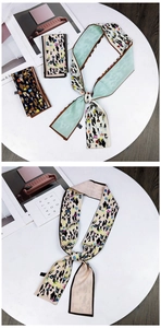 Detail of printed silk twilly scarf with abstract patterns and fine stitched edges