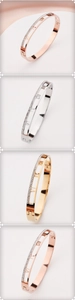 Detail of hollow Roman numeral bangles with sparkling diamonds in gold and rose gold