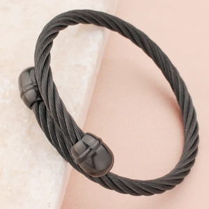 Black titanium steel twisted cable bangle featuring a polished open-end industrial design
