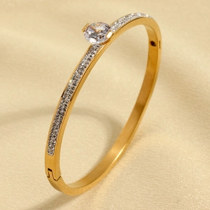 Elegant gold-plated stainless steel bangle with pavé crystals and a central cubic zirconia