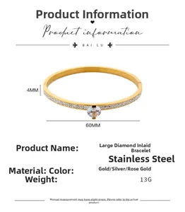 Close-up of 4mm gold stainless steel bangle with large center diamond and pave setting