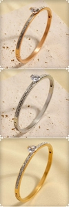 Detail of slim stainless steel bracelets in gold, silver and rose gold with pavé crystals