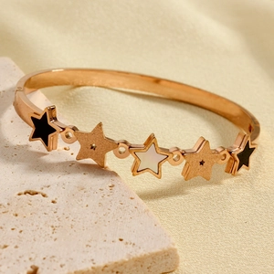 Rose gold stainless steel bangle with pentagram charms in black enamel and mother of pearl