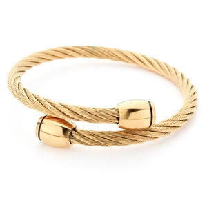 Detail view of gold twisted cable stainless steel cuff bracelet with industrial ends