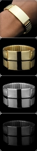Close-up of flexible stainless steel watch band bracelets in gold, silver, and black finish