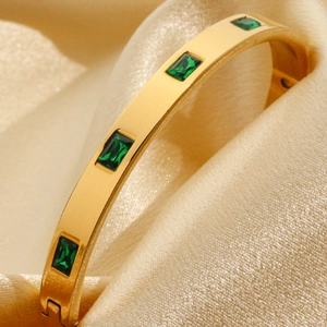 Gold-plated stainless steel bangle with rectangular emerald green stones on champagne silk