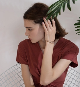 Close-up of dual-tone rose gold and silver bangle with zircon accents on wrist