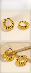 Close-up of 18K gold plated hollow croissant twist hoop earrings with textured detail