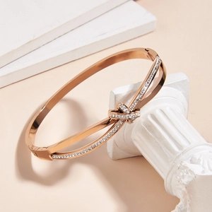 Elegant rose gold titanium steel bracelet with pavé crystals and crisscross design