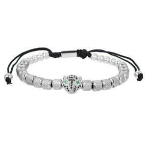 Detail of silver leopard head bracelet with green eyes and textured metal pineapple beads