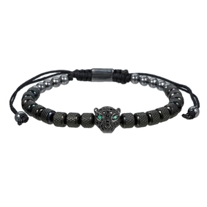 Macro shot of leopard head bead bracelet with green stone eyes and matte black beads