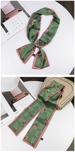 Detail of floral and plaid silk scarf in dark green with smooth polyester satin texture