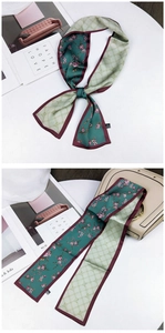 Detail of double-sided floral scarf with green flower print and beige geometric pattern