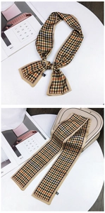 Close-up of double-sided houndstooth twilly scarf tied on a handbag handle